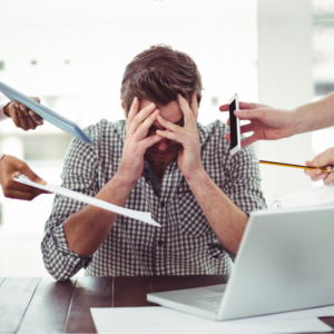 Man stressing at work desk