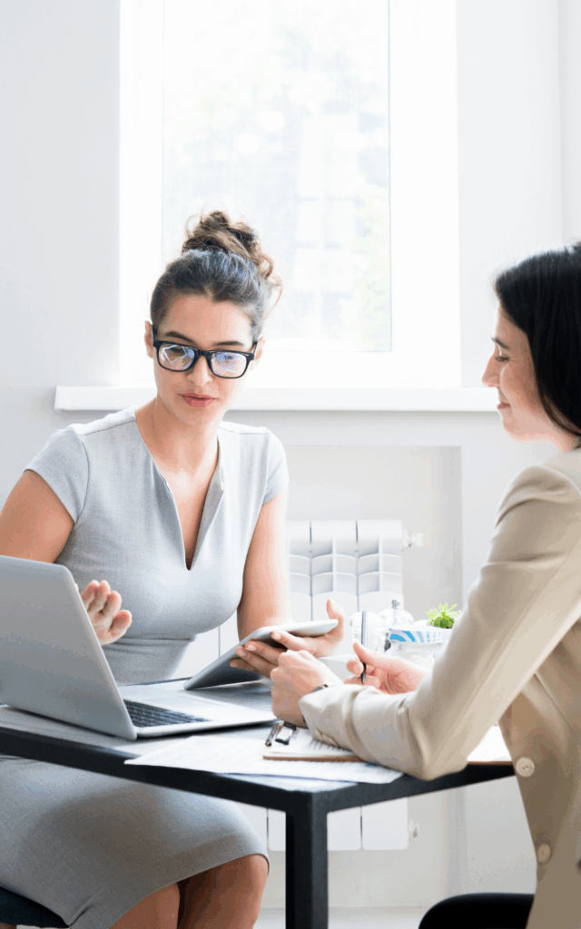 Executive Coaching Powered by Leadership Accelence with Accelus Partners, Texas leadership experts, coaches and speakers. - two women working together at a desk.